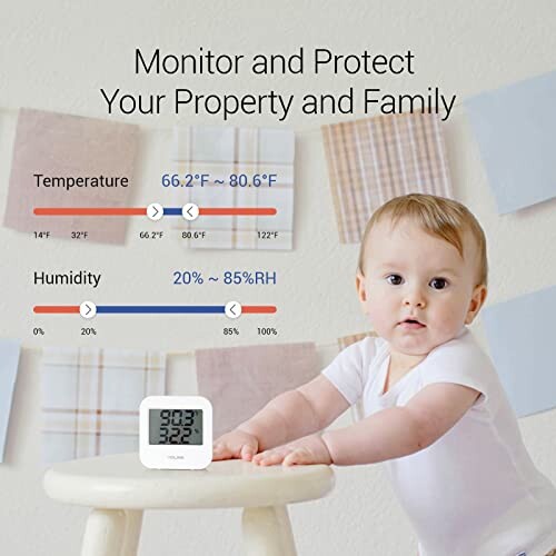 Baby with temperature and humidity monitor displaying readings.