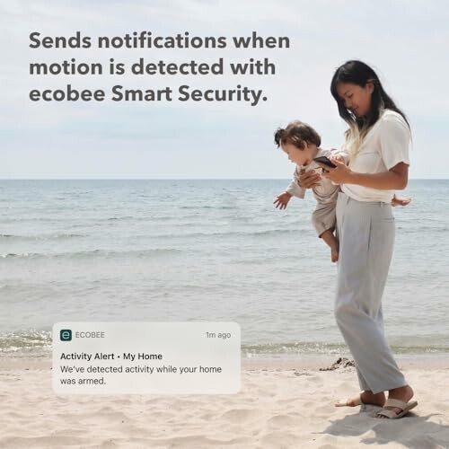 Woman on beach receiving Ecobee motion detection alert