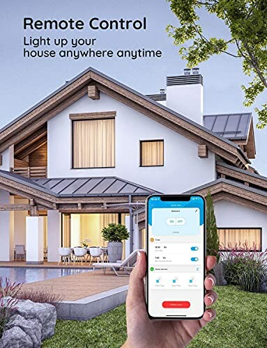 Hand holding smartphone with smart home lighting control app in front of a modern house.